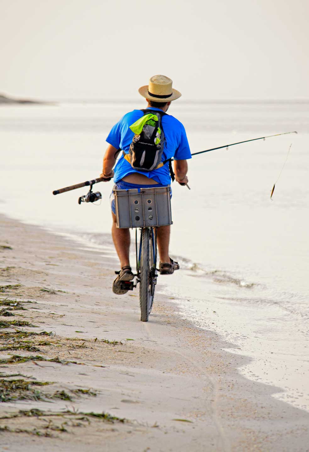 CJPOTY July 2023 shortlisted image for the Summer theme - cycling with a fishing rod